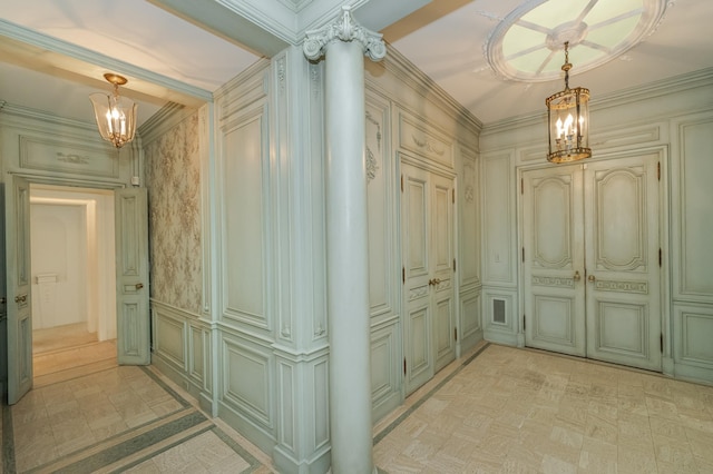 corridor with wainscoting, a notable chandelier, and a decorative wall