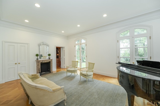 sitting room featuring ornamental molding, recessed lighting, a fireplace, and baseboards