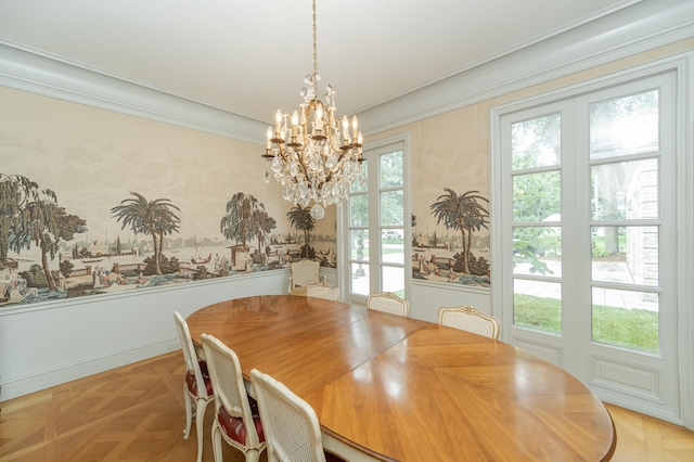 unfurnished dining area featuring a wainscoted wall, ornamental molding, and an inviting chandelier