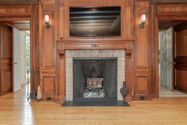 details featuring a fireplace with flush hearth and wood finished floors