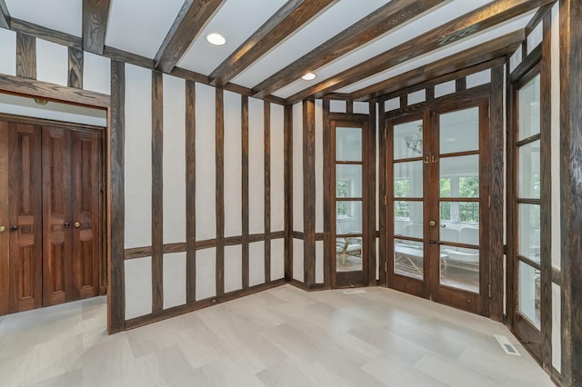 unfurnished sunroom with french doors, visible vents, and beamed ceiling