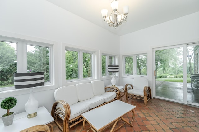 sunroom / solarium with vaulted ceiling and an inviting chandelier