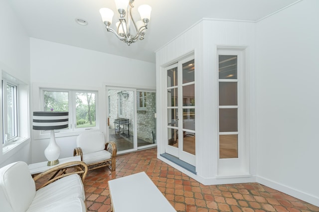 sunroom featuring a chandelier