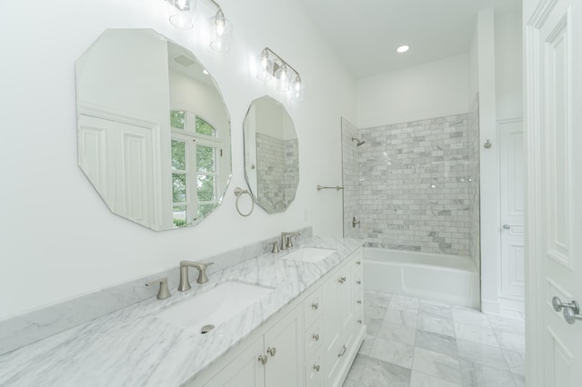 bathroom featuring double vanity, shower / washtub combination, and a sink