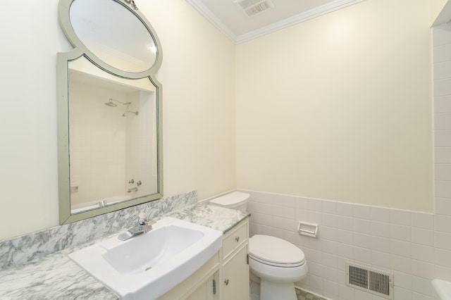 bathroom featuring visible vents, crown molding, tile walls, and toilet