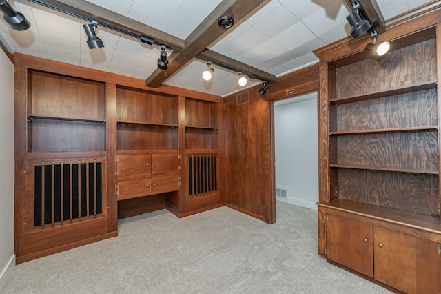 unfurnished living room with carpet floors, rail lighting, and visible vents