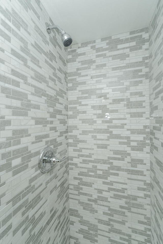 full bath featuring a tile shower