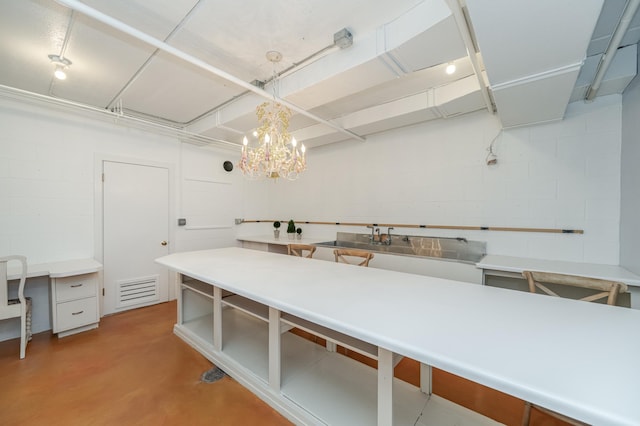 kitchen featuring visible vents, hanging light fixtures, light countertops, concrete floors, and open shelves