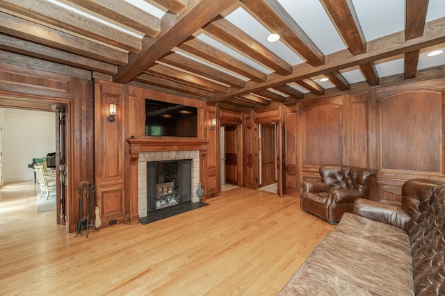 910 Folwell Dr SW, Rochester, MN 55902 - living room with wooden walls, beam ceiling, light wood finished floors, a fireplace with flush hearth, and coffered ceiling