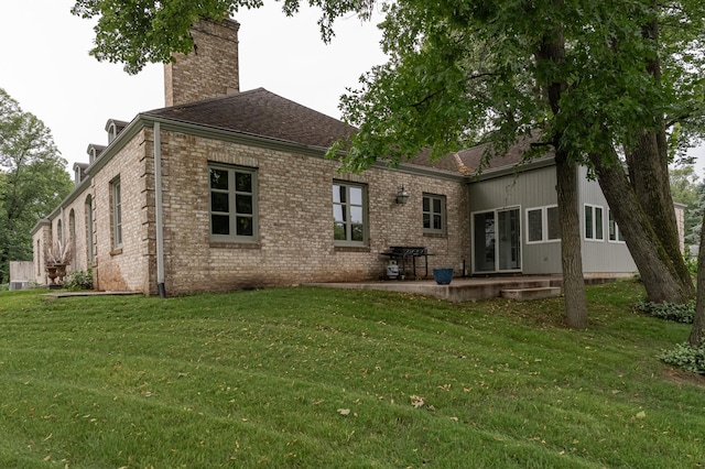 910 Folwell Dr SW, Rochester, MN 55902 - back of property featuring a patio area, brick siding, a lawn, and a chimney