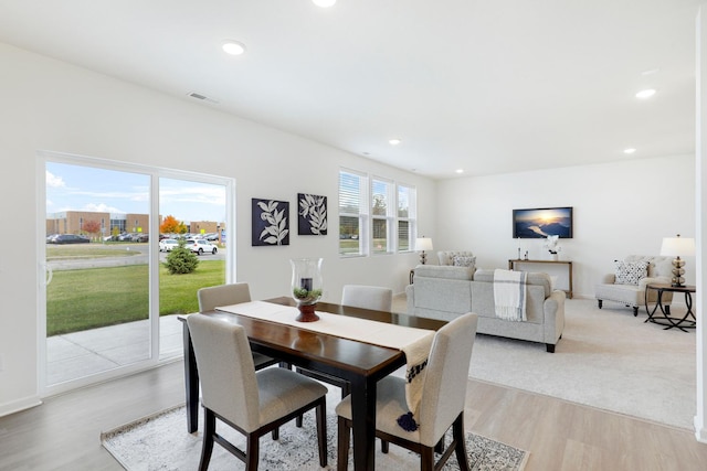 dining space with light hardwood / wood-style floors