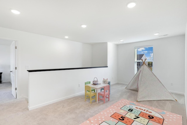 rec room with light carpet