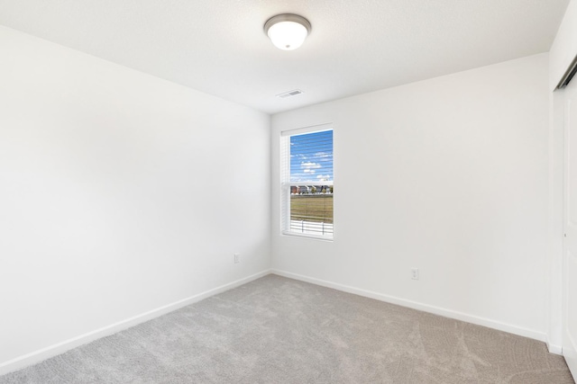 spare room with light colored carpet