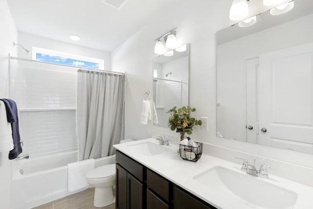 full bathroom featuring shower / tub combo, vanity, and toilet