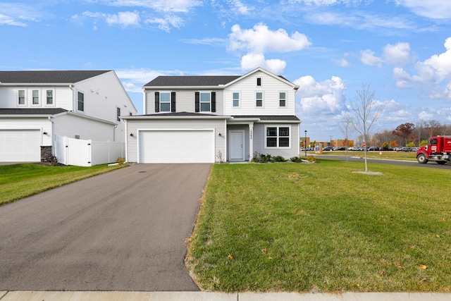 view of property with a garage and a front yard