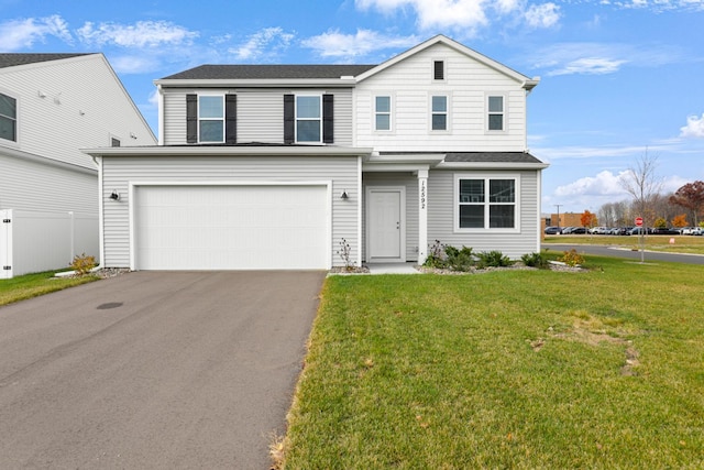 view of front property featuring a garage and a front yard