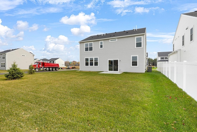 rear view of property with a patio, a yard, and cooling unit