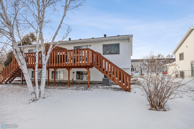 snow covered back of property with cooling unit