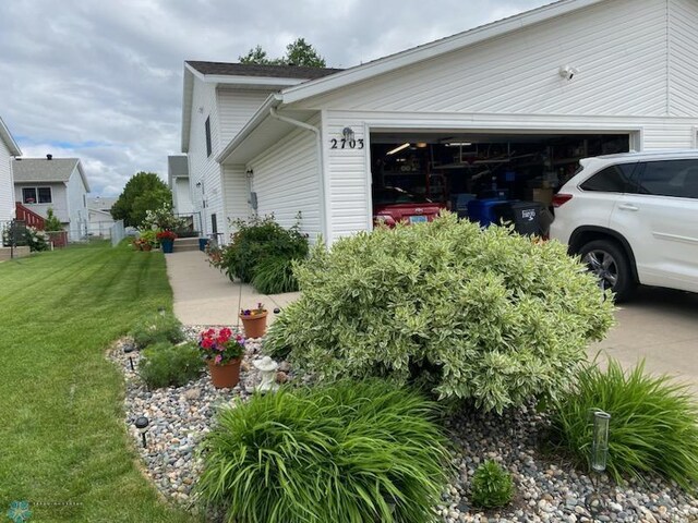 view of property exterior featuring a garage and a yard