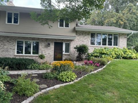 tri-level home with a front yard