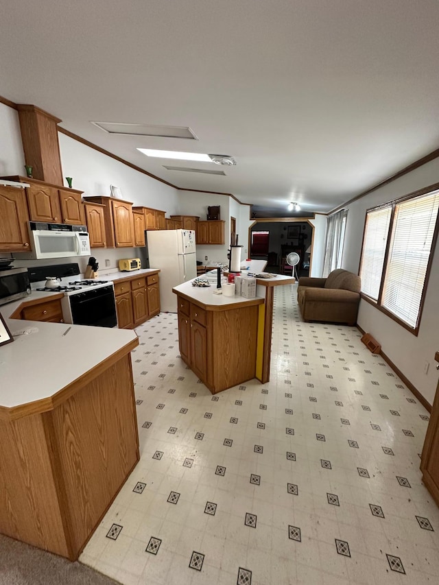 kitchen featuring white appliances, light countertops, brown cabinets, and light floors