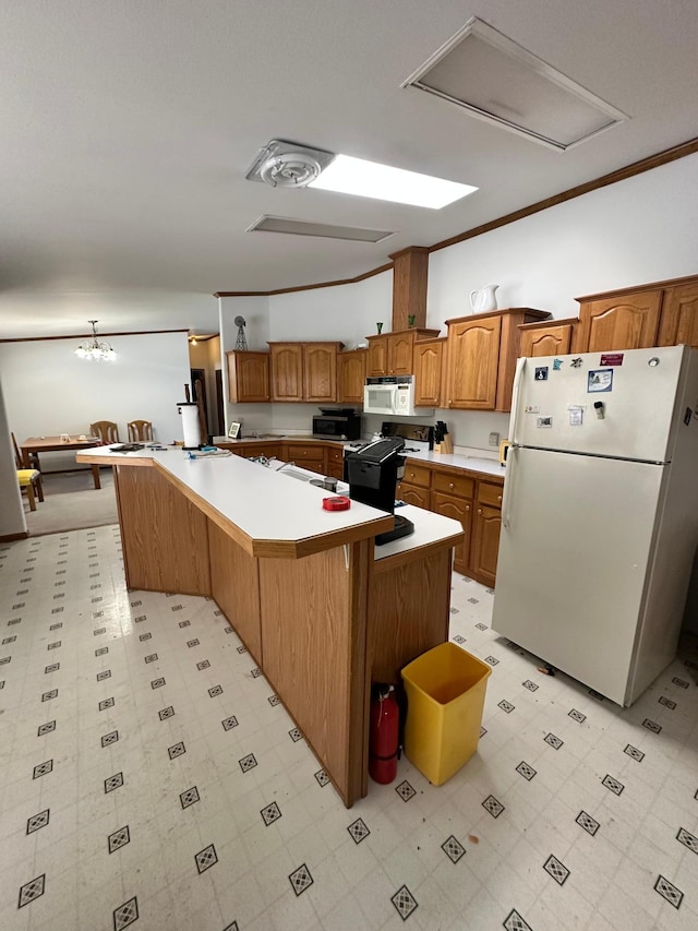 kitchen featuring white appliances, brown cabinetry, light floors, and light countertops