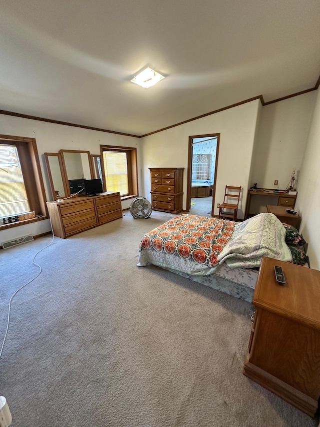 bedroom featuring carpet flooring, crown molding, and visible vents