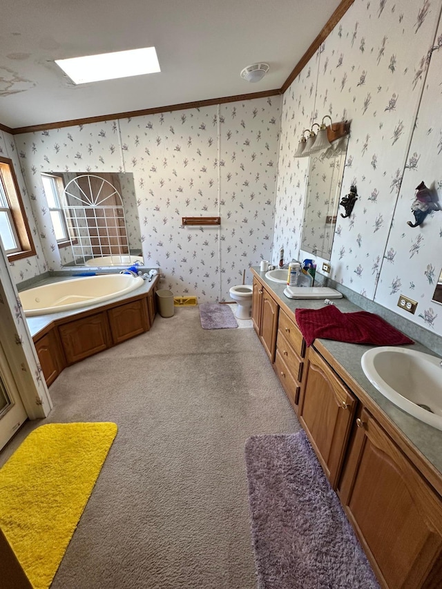 bathroom with a garden tub, vanity, crown molding, and wallpapered walls