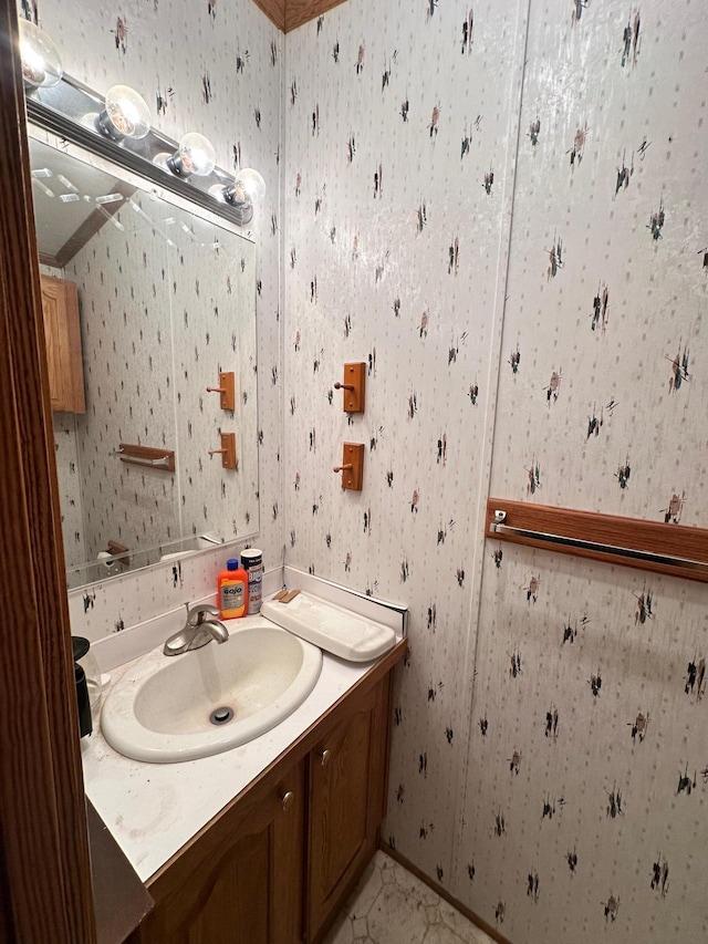 bathroom with vanity and wallpapered walls