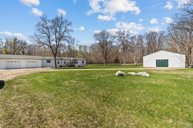 59001 County Highway 8, Sebeka, MN 56477 - view of green lawn with a garage, dirt driveway, view of wooded area, and an outdoor structure