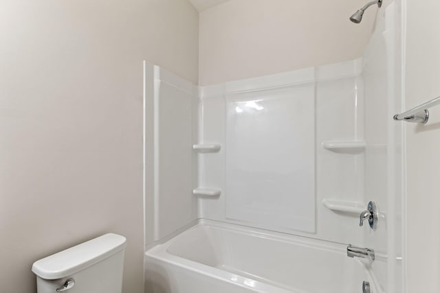 bathroom featuring toilet and bathing tub / shower combination