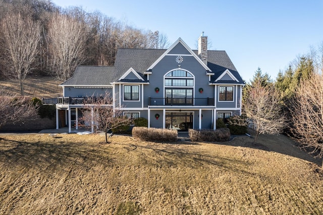 rear view of property with a lawn