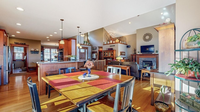 dining room featuring a fireplace and light hardwood / wood-style floors