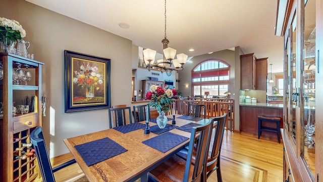 dining space with a chandelier and light wood-type flooring