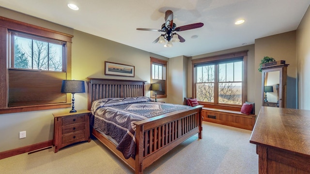 bedroom featuring light colored carpet and ceiling fan