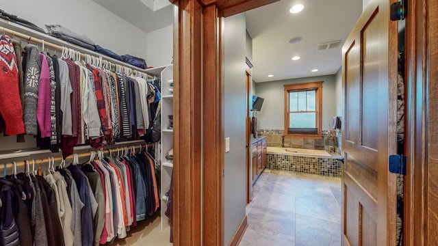 spacious closet with light tile patterned flooring