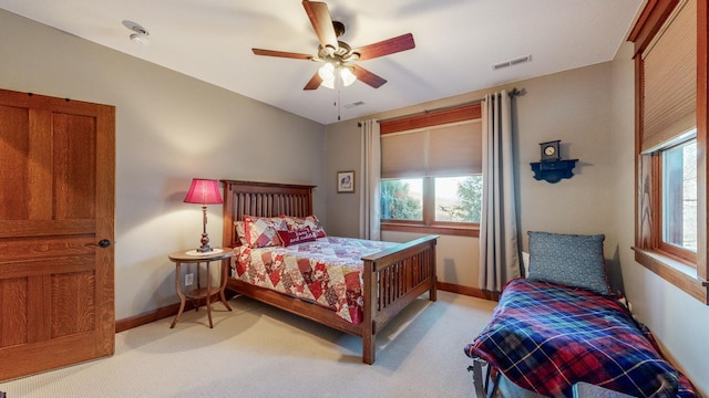 bedroom with ceiling fan and light carpet