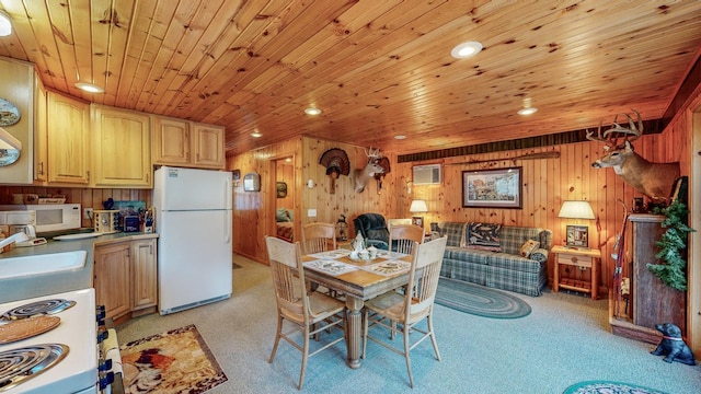 carpeted dining space with sink, wooden ceiling, an AC wall unit, and wood walls