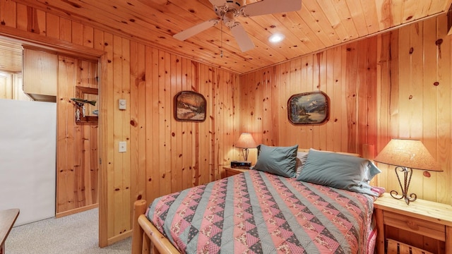 carpeted bedroom featuring wooden ceiling and wooden walls