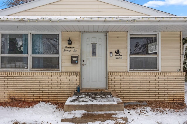 view of snow covered property entrance