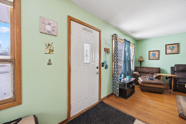 foyer with hardwood / wood-style flooring and a textured ceiling