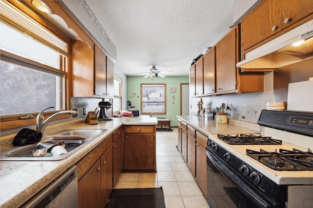 kitchen featuring sink, dishwasher, a textured ceiling, light tile patterned flooring, and range with gas cooktop