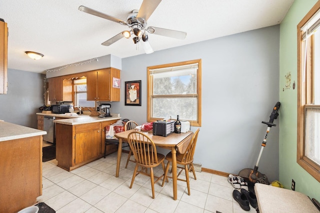 dining room featuring light tile patterned flooring, ceiling fan, a textured ceiling, and a wealth of natural light