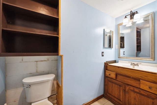 bathroom featuring vanity, tile patterned flooring, and toilet