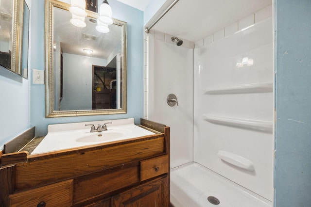 bathroom featuring vanity and a shower