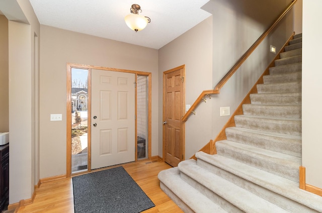 foyer entrance with light wood-type flooring