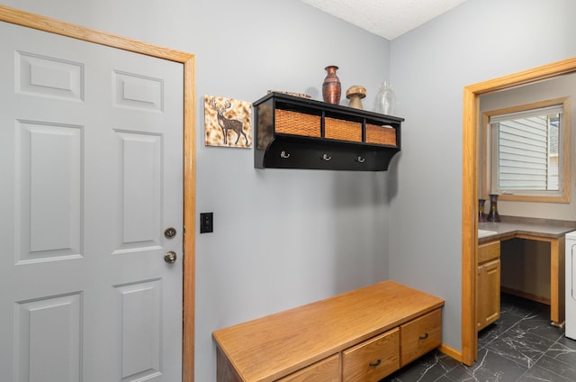 mudroom featuring a textured ceiling