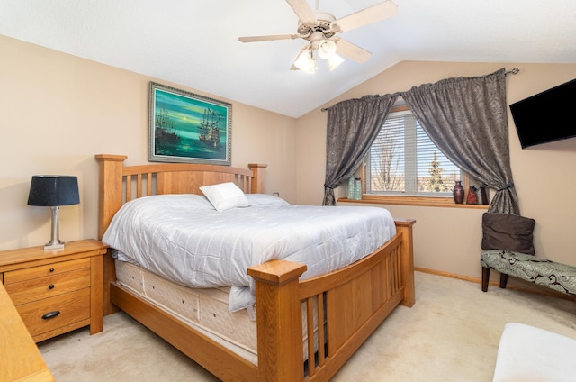 bedroom with ceiling fan, vaulted ceiling, and light carpet