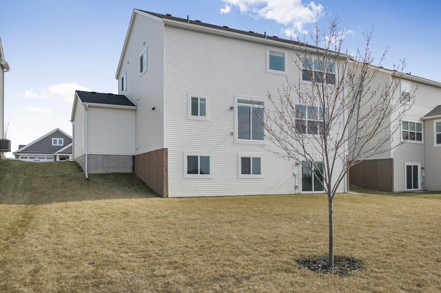 back of house featuring a yard and central AC