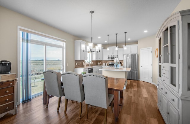 dining room with dark hardwood / wood-style flooring, sink, and a chandelier